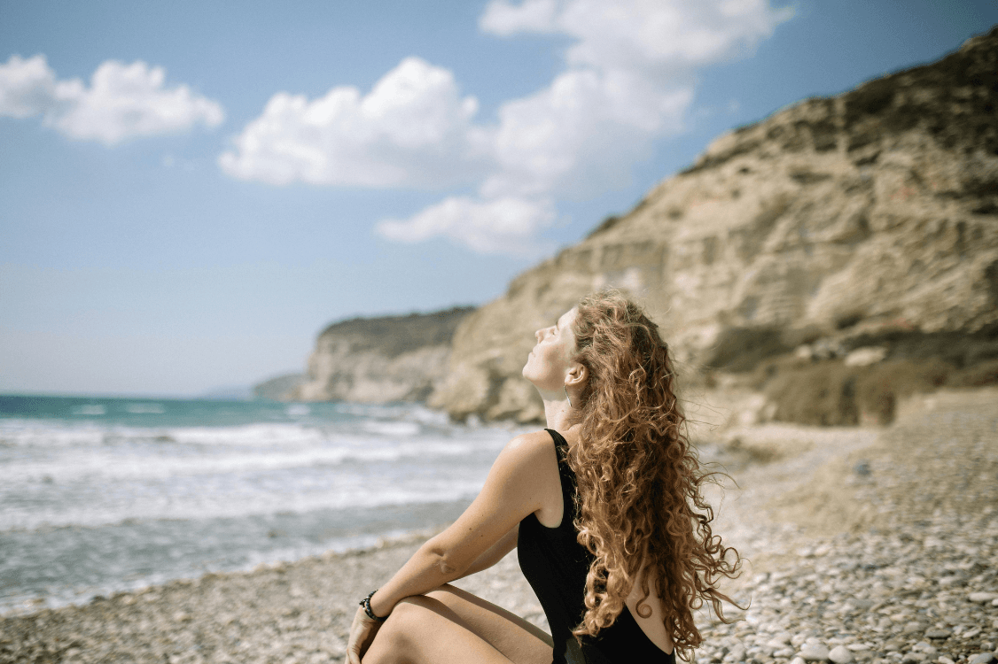 woman sitting beside the beach